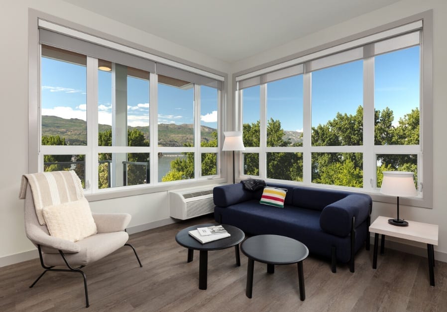 Living room with large windows in 2 Bedroom vacation rental suite at The Shore Kelowna