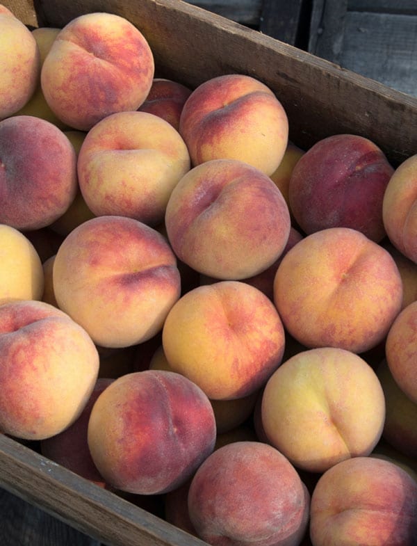 Peaches in a wooden crate