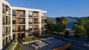 The Shore Kelowna on Okanagan lake, with an outdoor terrace and fireplace for guests to enjoy, shown here on a sunny day in the Okanagan