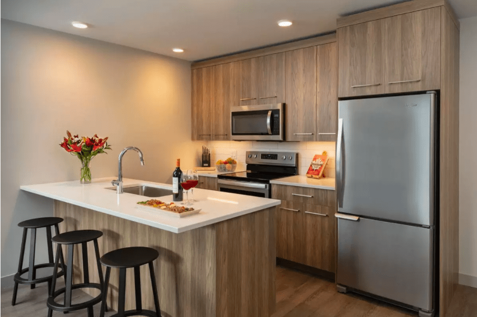 The Shore Kelowna in-suite kitchen with stainless steel appliances and everything you need for enjoying after a meal during your winter vacation.