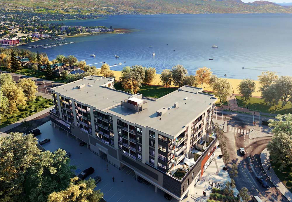 a birds eye view of The Shore Kelowna hotel with Gyro beach and Okanagan lake in the background