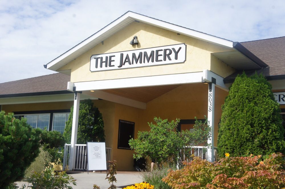 the front entrance of jammery breakfast and brunch restaurant in kelowna, showing the logo and light yellow siding