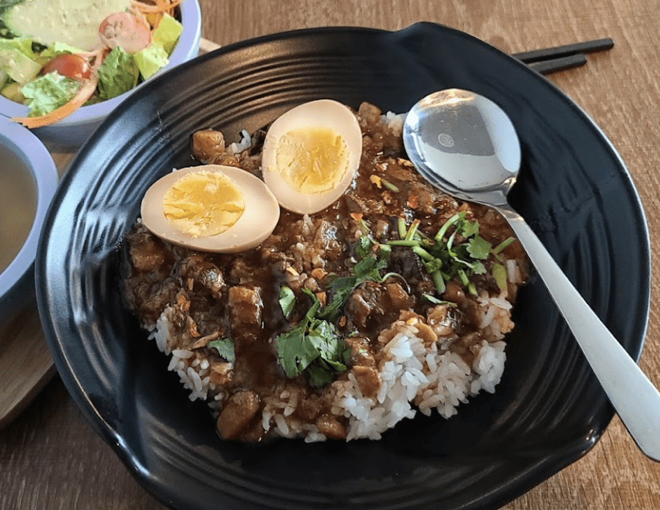A Minced Pork Bowl over rice with a hard boiled egg.