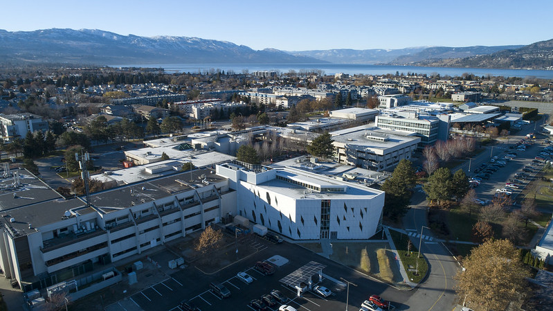 birds-eye view of the Okanagan College campus with Kelowna, with Okanagan lake and mountains in the background