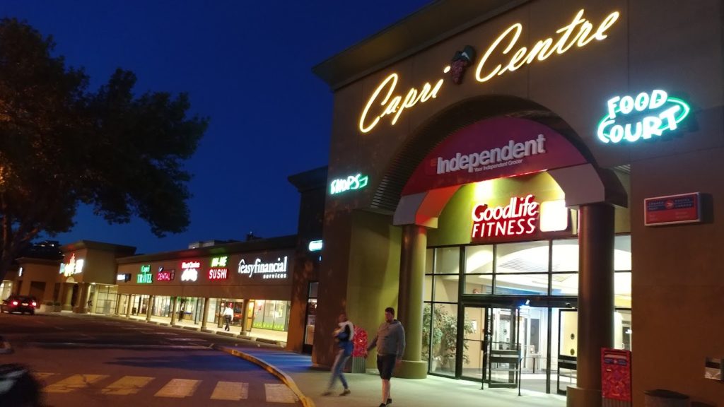 Capri Centre Mall in Kelowna at night, with neon lights highlighting the centre, the food court, goodlife fitness and other stores