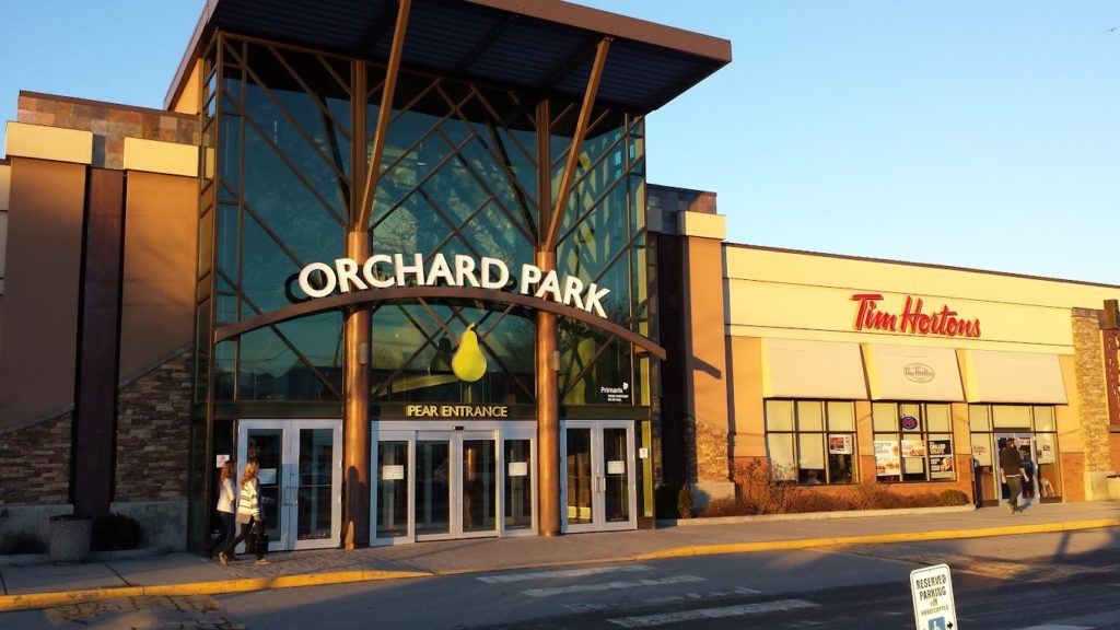 Exterior view of Orchard Park Shopping Centre in Kelowna, the pear entrance with a Tim Hortons sign next to the main entrance